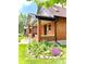 Charming brick home with a well-manicured lawn and colorful flower garden, enhancing curb appeal at 1731 S Ogden St, Denver, CO 80210