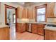Well-lit kitchen with wooden cabinets, stainless steel appliances, and granite countertops at 1731 S Ogden St, Denver, CO 80210