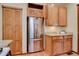 Kitchen featuring stainless steel refrigerator and wooden cabinets with granite countertops at 1731 S Ogden St, Denver, CO 80210