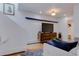 Modern living room with stylish wood cabinet, large TV, and comfortable seating arrangement at 1731 S Ogden St, Denver, CO 80210