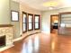 Living room with hardwood floors, fireplace, bay window, and built-in shelving at 1731 S Ogden St, Denver, CO 80210