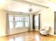 Bright living room featuring hardwood floors, large windows, and a modern chandelier at 1731 S Ogden St, Denver, CO 80210