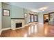 Inviting living room features a stone fireplace, wood floors, and bay windows for natural light at 1731 S Ogden St, Denver, CO 80210