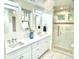 A beautifully renovated main bathroom showcases quartz counters and walk-in shower with bench seating at 1731 S Ogden St, Denver, CO 80210