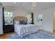 Spacious main bedroom with vaulted ceilings, a chandelier, and an ensuite bathroom at 1731 S Ogden St, Denver, CO 80210