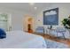 Bright main bedroom featuring hardwood floors and access to a walk-in closet and bathroom at 1731 S Ogden St, Denver, CO 80210