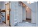 Spacious walk-in closet with built-in shelving and hanging space, adjacent to a bathroom at 1731 S Ogden St, Denver, CO 80210