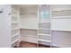 Spacious walk-in closet with built-in shelves and hanging rods for storage at 1731 S Ogden St, Denver, CO 80210