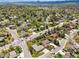 Overview of a residential area with lush trees, single-Gathering homes, and vehicle traffic at 3229 Swadley St, Wheat Ridge, CO 80033
