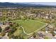 Aerial view of a suburban neighborhood with a park at 3229 Swadley St, Wheat Ridge, CO 80033