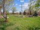 A large backyard with mature trees, grass, and wooden fence at 3229 Swadley St, Wheat Ridge, CO 80033
