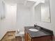Bathroom featuring tile floors, granite countertop vanity and wall mirror at 3229 Swadley St, Wheat Ridge, CO 80033