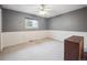 Neutral bedroom featuring light carpet and baseboard, gray walls and window at 3229 Swadley St, Wheat Ridge, CO 80033