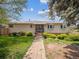 Charming single-story home with a welcoming entrance and neatly landscaped front yard at 3229 Swadley St, Wheat Ridge, CO 80033