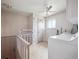 Bright laundry room featuring a washer, dryer and ceiling fan at 3229 Swadley St, Wheat Ridge, CO 80033