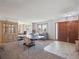 Open-concept living area with a dining table, comfortable seating, and a view of the front entrance at 3229 Swadley St, Wheat Ridge, CO 80033