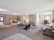 Spacious living room featuring a fireplace, large dining table, and ample natural light at 3229 Swadley St, Wheat Ridge, CO 80033