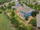 Aerial view of a blue home showing a lush backyard with a garden, a patio, and wood fencing at 19067 W 57Th Dr, Golden, CO 80403