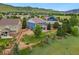 Aerial view of the home's backyard, a garden, and a covered patio with mountain views in the background at 19067 W 57Th Dr, Golden, CO 80403