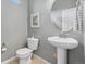Powder room with pedestal sink, toilet, and neutral tones at 19067 W 57Th Dr, Golden, CO 80403