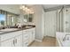 Bright bathroom featuring a double vanity with white cabinets and a tiled floor at 19067 W 57Th Dr, Golden, CO 80403