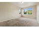 Bedroom showcasing ample natural light and a large carpeted space at 19067 W 57Th Dr, Golden, CO 80403
