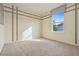Cozy bedroom with neutral carpeting, decorative wall trim and a bright window at 19067 W 57Th Dr, Golden, CO 80403