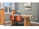 Dining room features a wooden table, leather chairs, modern decor, and large windows for natural light at 19067 W 57Th Dr, Golden, CO 80403