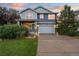 Beautiful two-story home with a well-manicured lawn and a two-car garage at 19067 W 57Th Dr, Golden, CO 80403