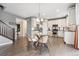 Modern kitchen with stainless steel appliances, white cabinets, and a glass dining table with stylish chairs at 19067 W 57Th Dr, Golden, CO 80403