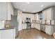 Spacious kitchen features stainless steel appliances, white cabinetry, and hardwood flooring at 19067 W 57Th Dr, Golden, CO 80403