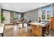Open-concept living room featuring modern decor, hardwood floors, contemporary furniture, and lots of sunlight at 19067 W 57Th Dr, Golden, CO 80403