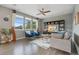 Bright living room featuring hardwood floors, contemporary furniture, and large windows for natural light at 19067 W 57Th Dr, Golden, CO 80403