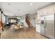 Open concept living space with dining area, living room, and staircase at 19067 W 57Th Dr, Golden, CO 80403