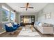 Bright living room with high ceilings featuring comfortable seating, a ceiling fan, and lots of sunlight at 19067 W 57Th Dr, Golden, CO 80403
