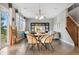 Open living space featuring hardwood floors, dining area, comfortable seating, and lots of natural light at 19067 W 57Th Dr, Golden, CO 80403