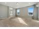 Sunlit main bedroom with dual windows, neutral carpet, and an ensuite bathroom at 19067 W 57Th Dr, Golden, CO 80403