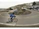 Cyclist rides along a winding road through the mountains, showcasing scenic routes at 19067 W 57Th Dr, Golden, CO 80403