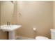 Half-bathroom with pedestal sink and toilet, minimalist and clean design at 1333 Elati St # 3, Denver, CO 80204