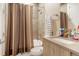Well-lit bathroom featuring a shower and vanity with neutral tones at 1333 Elati St # 3, Denver, CO 80204