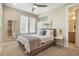 Bright bedroom features a ceiling fan, carpet floors, and a mirror reflecting the walk-in closet, bathed in natural light at 1333 Elati St # 3, Denver, CO 80204