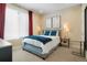 Bedroom featuring a window with curtains, carpet flooring, and stylish decor, creating a cozy and inviting space at 1333 Elati St # 3, Denver, CO 80204