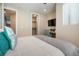 Bedroom featuring a TV, desk, large windows, and a walk-in closet, providing ample storage and modern comfort at 1333 Elati St # 3, Denver, CO 80204