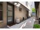 Townhouse front entrance with brick facade, leading to a modern door and well-maintained walkway at 1333 Elati St # 3, Denver, CO 80204