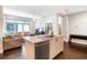 Kitchen island with stainless dishwasher, hardwood floors and view into an inviting living room at 1333 Elati St # 3, Denver, CO 80204