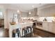 Modern kitchen featuring stainless steel appliances, light wood cabinetry, and a spacious island with seating at 1333 Elati St # 3, Denver, CO 80204