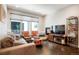 Bright living room with large windows, hardwood floors, a cozy fireplace and comfortable seating at 1333 Elati St # 3, Denver, CO 80204