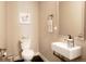 Stylish powder room featuring modern fixtures, a floating sink, and unique decor at 1333 Elati St # 3, Denver, CO 80204