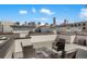 Stylish rooftop deck with modern seating and panoramic cityscape views at 1333 Elati St # 3, Denver, CO 80204
