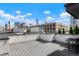 Relaxing rooftop deck with a grill and city skyline in the background at 1333 Elati St # 3, Denver, CO 80204